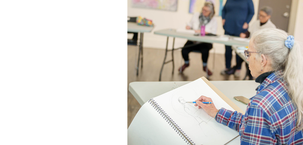 An artists working on a drawing of a woman